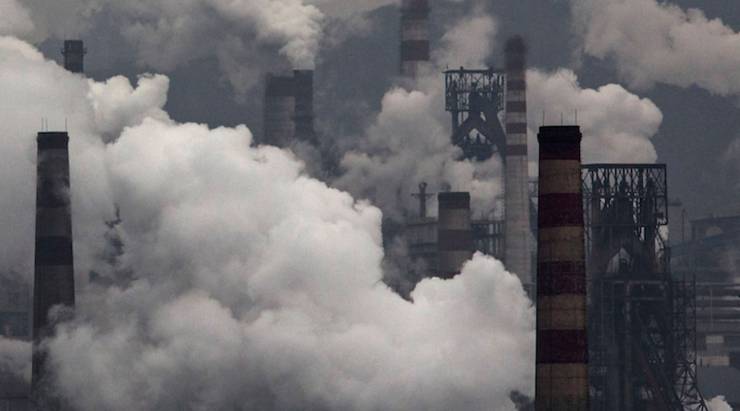 Smoke billows from smokestacks and a coal-fired generator at a steel factory in the industrial province of Hebei, China.
