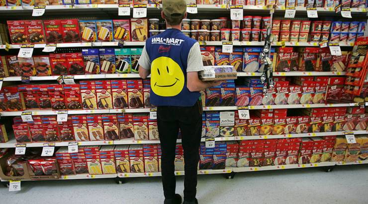 An employee restocks a shelf in the grocery section of a Wal-Mart Supercenter in 2005 in Troy, Ohio.