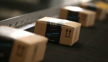Boxes move along a conveyor belt at an Amazon fulfillment center.