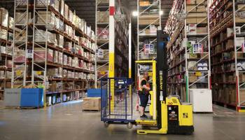 Workers pack and ship customer orders at the 750,000-square-foot Amazon fulfillment center in August in Romeoville, Illinois.