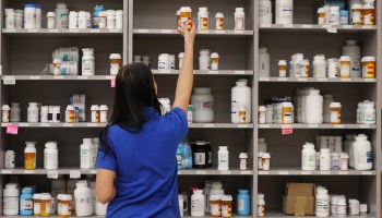 A pharmacy technician grabs a bottle of drugs off a shelve at the central pharmacy of Intermountain Heathcare on September 10, 2018 in Midvale, Utah. IHC along with other hospitals and philanthropies are launching a nonprofit generic drug company called "Civica Rx" to help reduce cost and shortages of generic drugs.