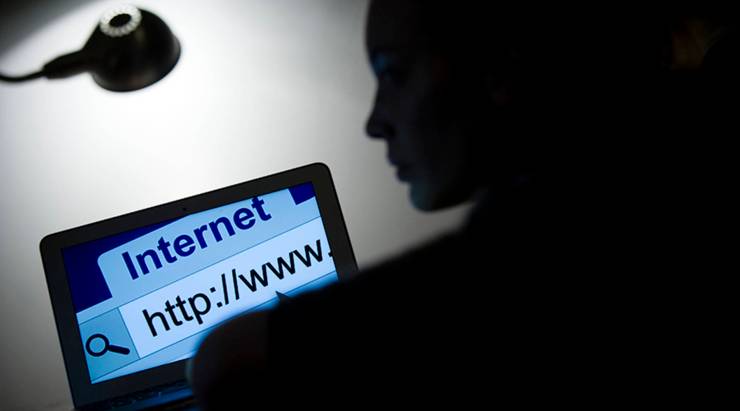 A woman looks at a webpage while connecting on the internet on March 15, 2013 in Paris.