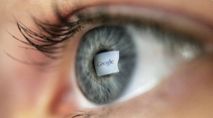 In this photo illustration, the logo of the multi-faceted internet giant Google is reflected in the eye of a woman looking at a computer screen, April 13, 2006 in London, England.