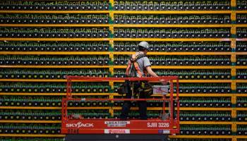 A technician inspects the backside of bitcoin mining at Bitfarms in Saint Hyacinthe, Quebec, in March.