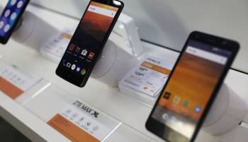 Two cellphones manufactured by ZTE, China's No. 2 smartphone maker, are seen on a Miami store shelf in May.