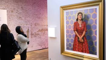 Attendees admire a painting of Henrietta Lacks at HBO's The HeLa Project Exhibit For "The Immortal Life of Henrietta Lacks" on April 6, 2017 in New York City. A lawsuit from Lacks' descendants brings up a host of ethical questions.