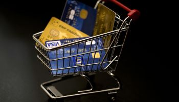 This illustration photo taken on December 22, 2012, in Paris, shows credit cards in a miniature toy shopping cart.