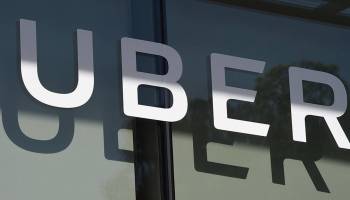 The Uber logo is seen at the second annual Uber Elevate Summit, on May 8, 2018 at the Skirball Center in Los Angeles, California.