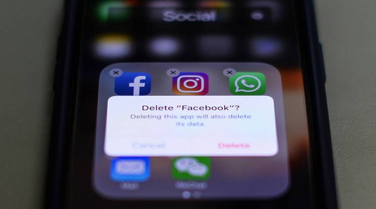 This photo illustration shows an iPhone message asking whether the user wants to delete Facebook