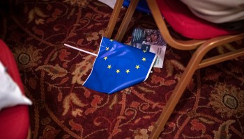 A discarded flag of the European Union is pictured on the floor of a conference room in Italy.