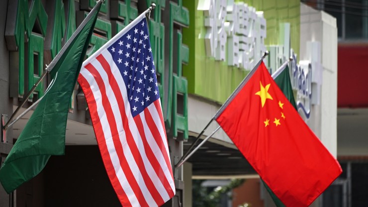 The U.S. and Chinese flags are displayed outside a hotel in Beijing.