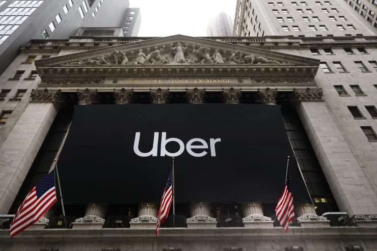 The Uber banner hangs outside of the New York Stock Exchange (NYSE) before the Opening Bell at the NYSE as the ride-hailing company Uber makes its highly anticipated initial public offering (IPO) on May 10, 2019 in New York City. Uber will start trading on the New York Stock Exchange after raising $8.1 billion in the biggest U.S. IPO in five years.Thousands of Uber and other app based drivers protested around the country on Wednesday to demand better pay and working conditions including sick leave, over time and a minimum wage.