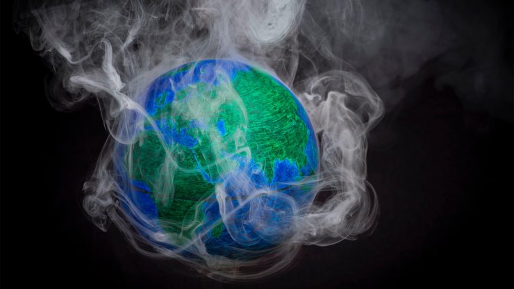 A picture shows a small globe surrounded by smoke to illustrate global warming.