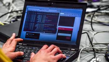 A person works at a computer during the 10th International Cybersecurity Forum in Lille on January 23, 2018.