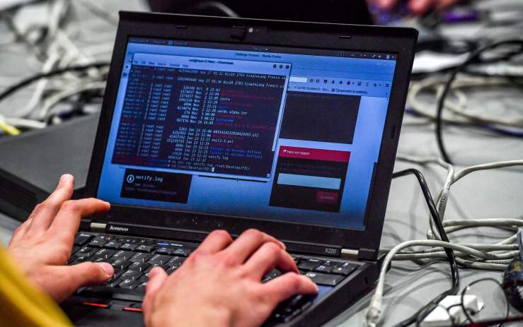 A person works at a computer during the 10th International Cybersecurity Forum in Lille on January 23, 2018.