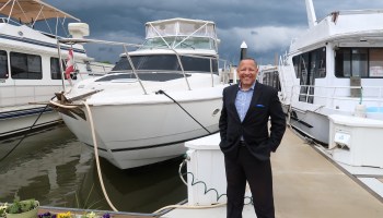 Darryl Madden, a full-time liveaboard boater, next to his 50 ft cruiser in Southwest DC.