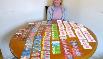 Judy sits at her kitchen table with $166,000 in used department store gift cards.