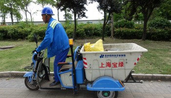 An elderly man picking trash along Shanghai's streets for $12 a day.