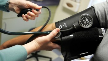 A doctor reads a blood pressure gauge in Dorchester, Maryland.