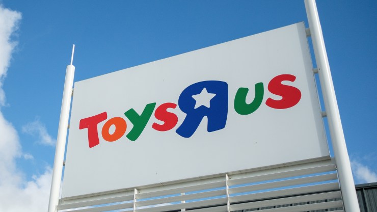 A Toys R Us sign on the outside of store.
