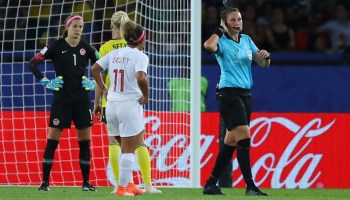 Referee Kate Jacewicz indicates she is going to use video assistant referee after awarding Sweden a penalty during a match with Canada at the Women's World Cup in Paris on June 24.