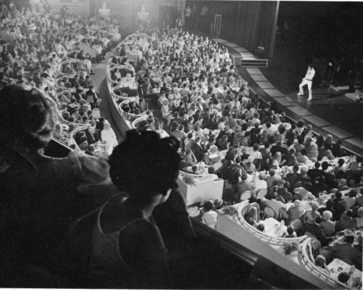 Elvis performing in front of a large crowd in Las Vegas