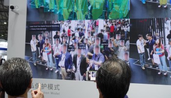 A Chinese tech firm showcases its facial recognition security equipment at the Consumer Electronics Show in Shanghai June 2019. The success of these companies is partly built on the backs of workers putting in extreme overtime.