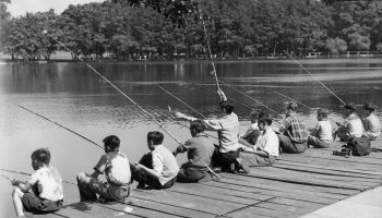 Children fish off a pier.