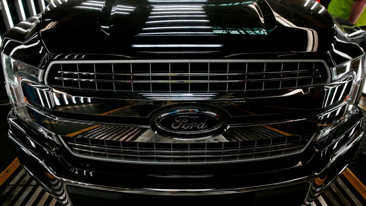 This photo shows a Ford logo on a front bumper as Ford 2018 and 2019 F-150 trucks sit on the assembly line at the Ford Motor Company's Rouge Complex on September 27, 2018 in Dearborn, Michigan.