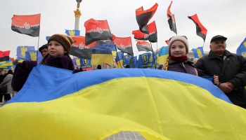 Ukrainian activists from different nationalist parties hold posters and flags as they take part at a rally in February