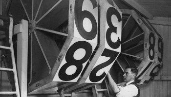 A scoreboard is changed at a cricket match in England in 1935.