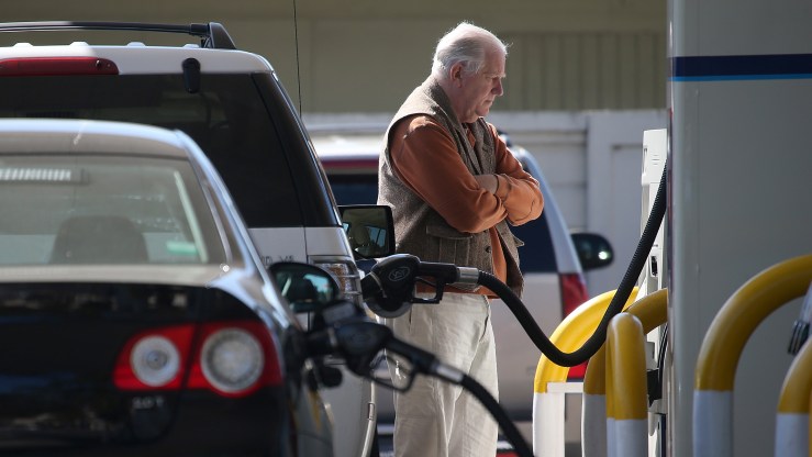 A customer pumps gas into his car at an Arco gas station in Mill Valley, California.