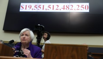 Then-Federal Reserve Chair Janet Yellen testifies before a House panel in 2016, with the national debt displayed in the background. Yellen, now nominated to run the Treasury Department, is focused on economic recovery.