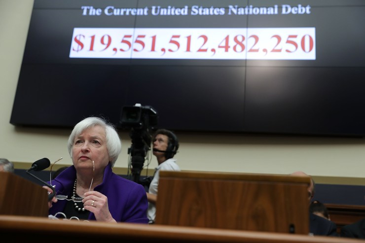 Then-Federal Reserve Chair Janet Yellen testifies before a House panel in 2016, with the national debt displayed in the background. Yellen, now nominated to run the Treasury Department, is focused on economic recovery.