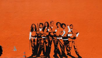 Paris teenagers stand by a mural depicting the Netflix series "Orange Is the New Black" in 2017.