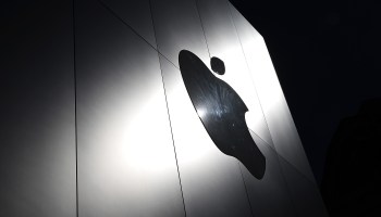 The Apple logo is displayed on the exterior of an Apple Store in San Francisco.