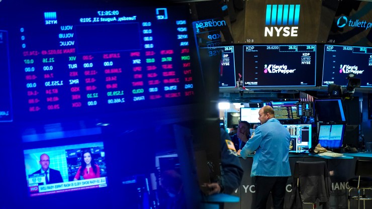 Traders and financial professionals work on the floor of the New York Stock Exchange (NYSE) at the opening bell on August 13, 2019 in New York City.