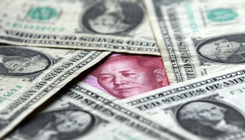 U.S. dollar bills pictured with the Chinese yuan.
