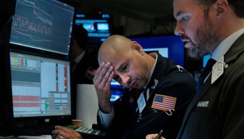 Traders work on the floor of the New York Stock Exchange on Wednesday. Stocks plummeted, with the Dow down over 800 points.