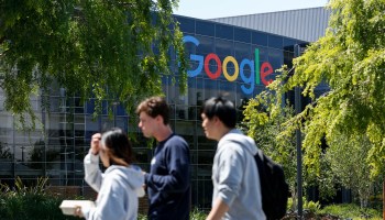 People walk in Google's main campus as a sit-in to protest against Google's retaliation against workers takes place within Google's main cafeteria in Mountain View, California, on May 1.