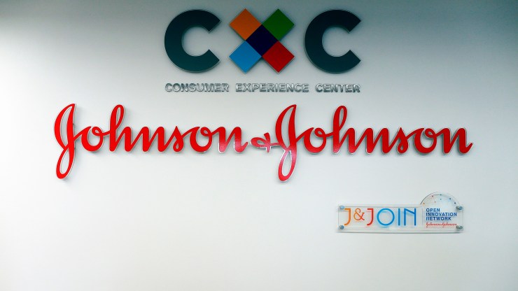 The logo of U.S. multinational medical devices and pharmaceutical company Johnson & Johnson at the entrance of the research and development plant in Val-de-Reuil, France.