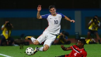 Christian Pulisic of the United States men's team is tackled by Kevon Villaroel of Trinidad and Tobago during the FIFA World Cup qualifier match in 2017 in Couva, Trinidad and Tobago.