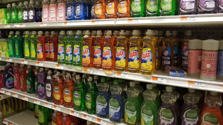 A variety of dish soap brands line supermarket shelves.