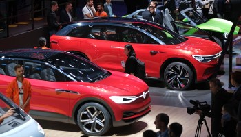 Visitors look at Volkswagen electric cars at the 2019 IAA Frankfurt auto show on Sept. 11 in Germany.
