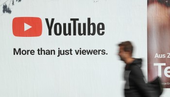 A man walks past a billboard advertisement for YouTube in 2018 in Germany.