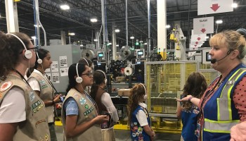 Regan Quilty leads a tour of Girl Scouts at the New Jersey Amazon fulfillment center. The girls learned how humans interact with robots at the warehouse.