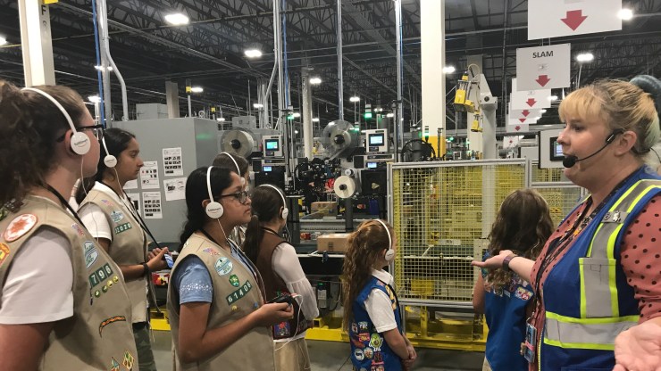 Regan Quilty leads a tour of Girl Scouts at the New Jersey Amazon fulfillment center. The girls learned how humans interact with robots at the warehouse.