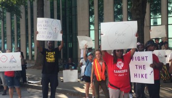 Dozens of people gathered outside the Georgia Public Service Commission building to protest Georgia Power’s proposal to raise electric rates.