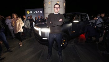 Amazon says it will order 100,000 electric delivery vans from Rivian. Above, Rivian CEO RJ Scaringe shows off the company's electric pickup truck at the Griffith Observatory in Los Angeles in 2018.
