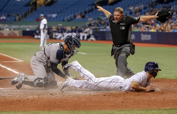 Home plate umpire Greg Gibson calls Andrew Velazquez of the Tampa Bay Rays safe in a game against the New York Yankees in St. Petersburg, Florida, in 2018. Photo by Mike Carlson/Getty Images